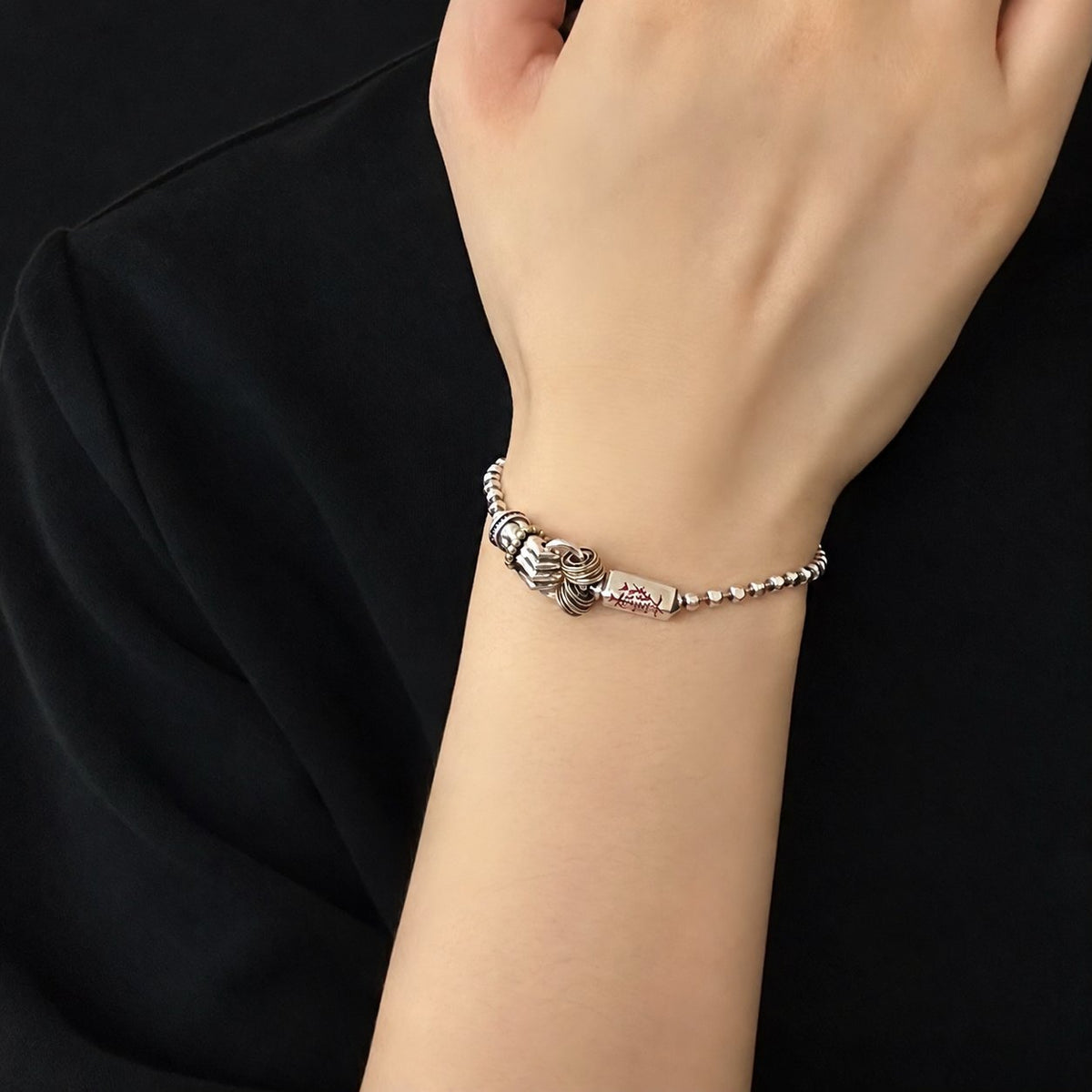 Men's Ritual Hilt Sterling Silver Bracelet in Sterling Silver with Gold-Tone Accents – contextual scene, on wrist with black cotton