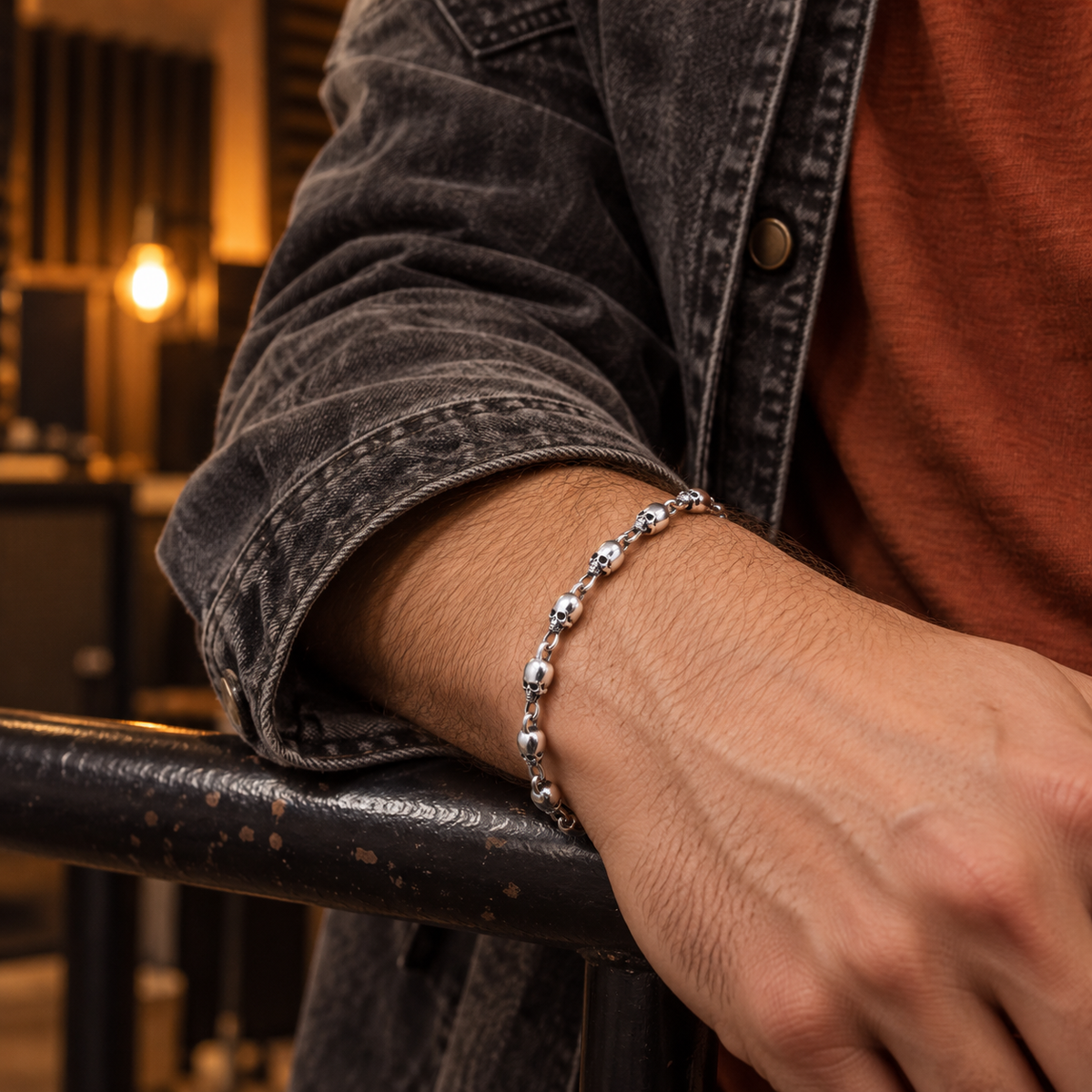 Men's Small Skull Chain in Sterling Silver – contextual scene, on wrist in a music studio