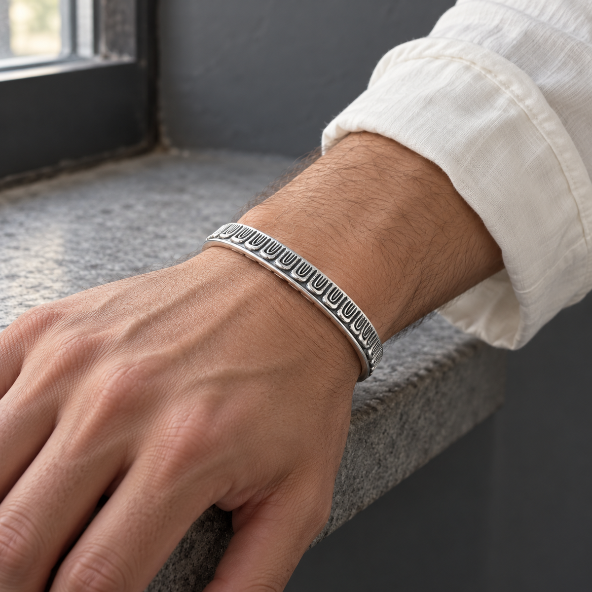 Men's U-Rib Cuff Bracelet in Sterling Silver – contextual scene, on wrist with ivory cotton