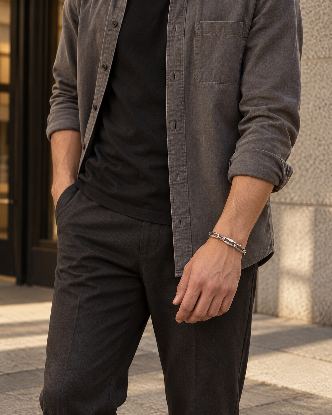 Faceted Bar Link Bracelet — contextual scene, torso and hands