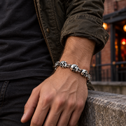 Men's Hollow Skull Ring Link Bracelet in Steel; Antiqued Silver-Tone Finish – contextual scene, on wrist