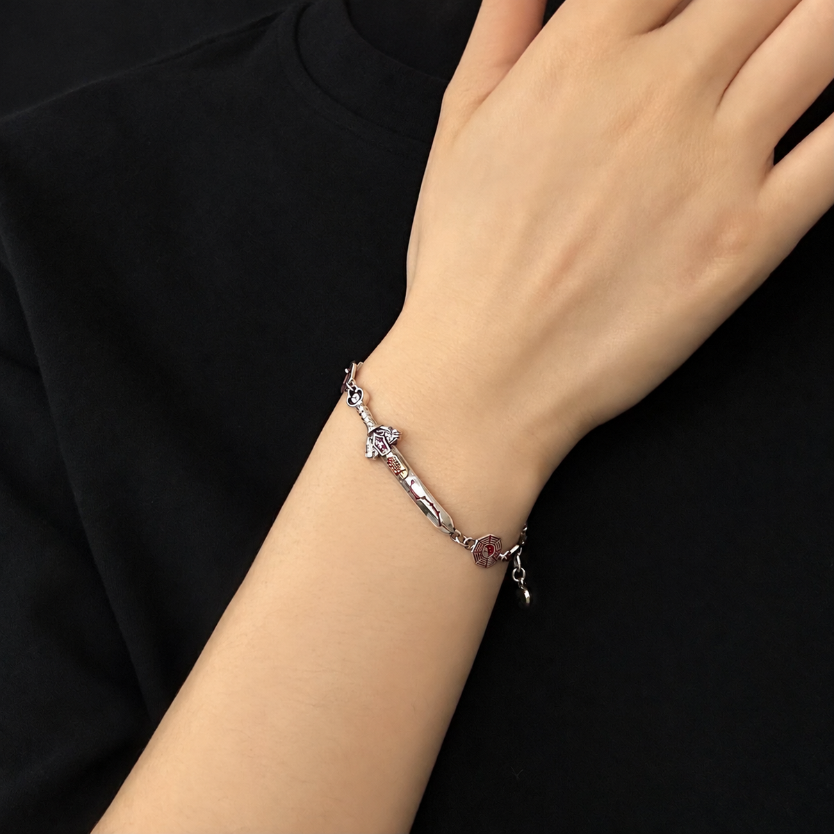 Men's Seven-Star Sword Bracelet in Sterling Silver – contextual scene, on wrist against black cotton