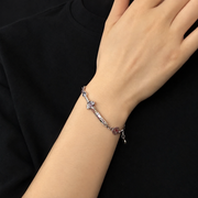 Men's Seven-Star Sword Bracelet in Sterling Silver – contextual scene, on wrist against black cotton