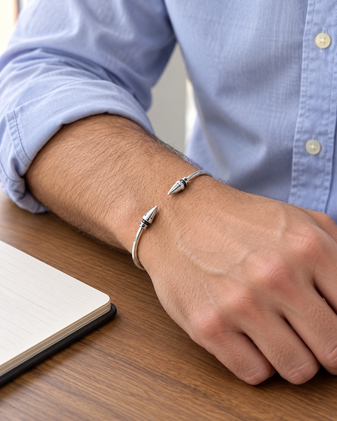 Men's Spike Tip Cuff in Sterling Silver – contextual scene, on wrist at a walnut desk