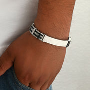Men's Rail Panel Bracelet in black and silver-tone stainless steel – contextual scene on wrist beside denim pocket