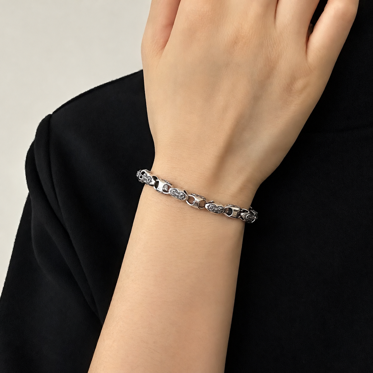 Men's Vajra Relief Bracelet in Sterling Silver – contextual scene, on wrist against black cotton