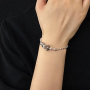 Men's Ritual Hilt Sterling Silver Bracelet in Sterling Silver with Gold-Tone Accents – contextual scene, on wrist with black cotton