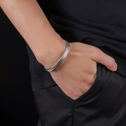 Men's Fine Mesh Open Cuff in silver-tone stainless steel – on wrist with black cotton