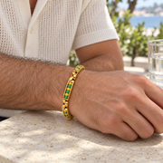 Men's Green Rhythm Link Bracelet in Gold Plated Steel – contextual scene, on wrist at an outdoor cafe