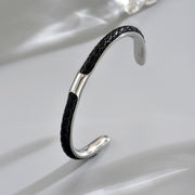 Men's Inlay Arc Cuff in black and silver-tone stainless steel – original angled detail of braided inlay and open ends