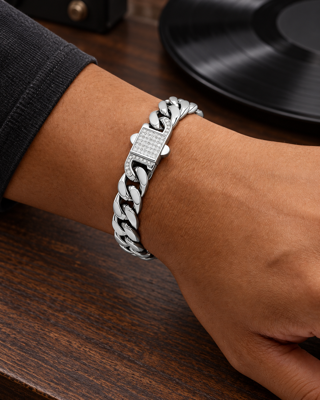 Men's Pavé Lock Cuban Bracelet in silver-tone Stainless Steel – contextual scene, on wrist beside a record player