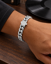 Men's Pavé Lock Cuban Bracelet in silver-tone Stainless Steel – contextual scene, on wrist beside a record player