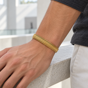 Men's Flat Herringbone Bracelet in Gold-Tone Plated Steel – contextual scene, on wrist