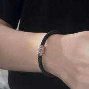 Men's Script Barrel Sterling Silver Cord Bracelet in Sterling Silver and Black Textile Cord – contextual scene, on wrist with black cotton
