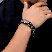 Men's Industrial Twin Rail Bracelet in Aged Silver-Tone Steel – contextual scene, on wrist with dark clothing