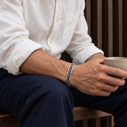 Men's Vajra Channel Sterling Silver Cuff in Sterling Silver – contextual scene, on wrist with off-white cotton