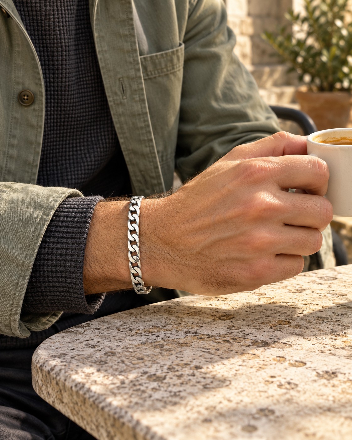 Men's Open Curb Sterling Silver Cuff in Sterling Silver – contextual scene, slim cuff on wrist with sage cotton and charcoal knitwear