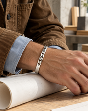 Men's Curb Front Sterling Silver Cuff in Sterling Silver – contextual scene, on wrist with a tobacco cotton jacket and blue oxford cuff