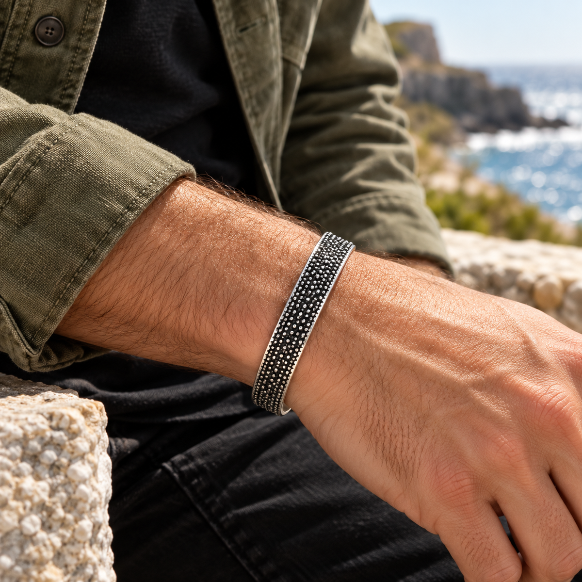 Men's Granular Texture Cuff in Sterling Silver – contextual scene, on wrist with an olive canvas overshirt