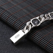 Men's Spaced Skull Curb Bracelet in Sterling Silver – original S925 box-clasp detail