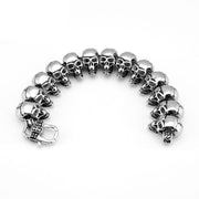 Men's Cracked Skull Row Bracelet in Steel; Silver-Tone or Gold-Tone Finish – original engraved skulls and belt-style buckle detail