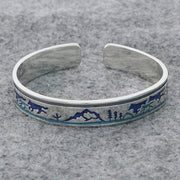 Men's Blue Wilderness Cuff in Silver-Tone / Blue – original wolves, mountains and pine-tree detail