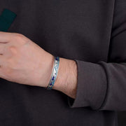 Men's Blue Wilderness Cuff in Silver-Tone / Blue – contextual scene, on wrist with a charcoal knit sleeve