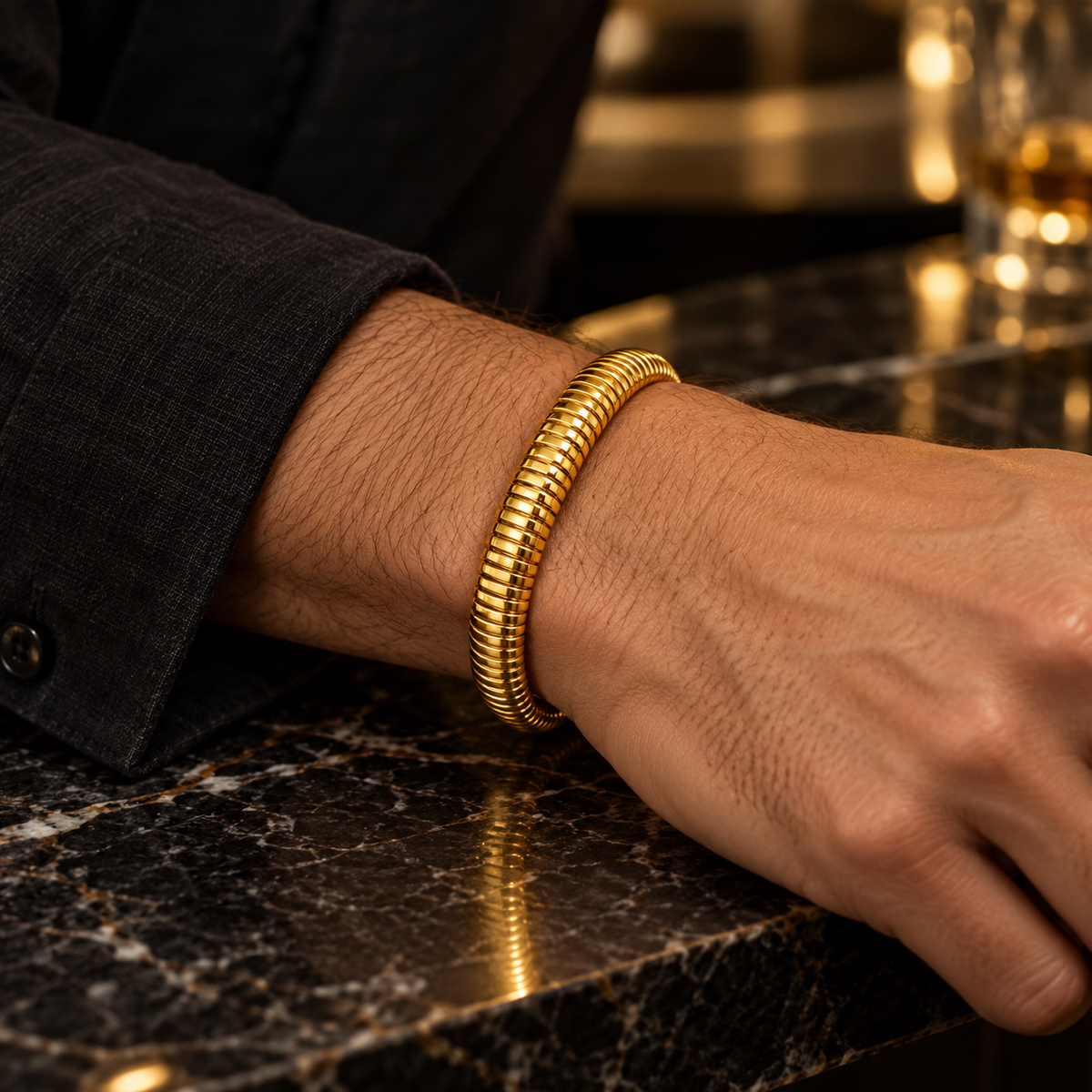 Men's Ribbed Coil Bangle in Gold-Tone Plated Steel – contextual scene, on wrist