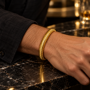 Men's Ribbed Coil Bangle in Gold-Tone Plated Steel – contextual scene, on wrist