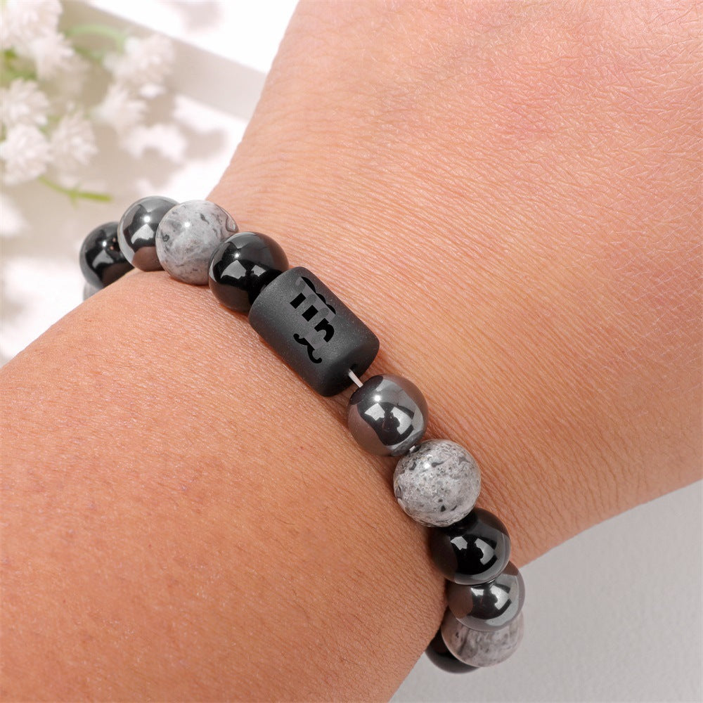 Men's Zodiac Cylinder Bracelet in black and grey decorative glass beads – contextual scene, Scorpio on wrist
