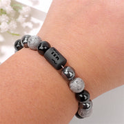 Men's Zodiac Cylinder Bracelet in black and grey decorative glass beads – contextual scene, Scorpio on wrist