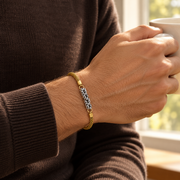 Men's Woven Scroll Bracelet in Gold-Tone Plated Steel – contextual scene, on wrist