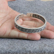 Men's Interlace Scale Cuff in Sterling Silver – original hand-held view of the interlace relief and S925 hallmark