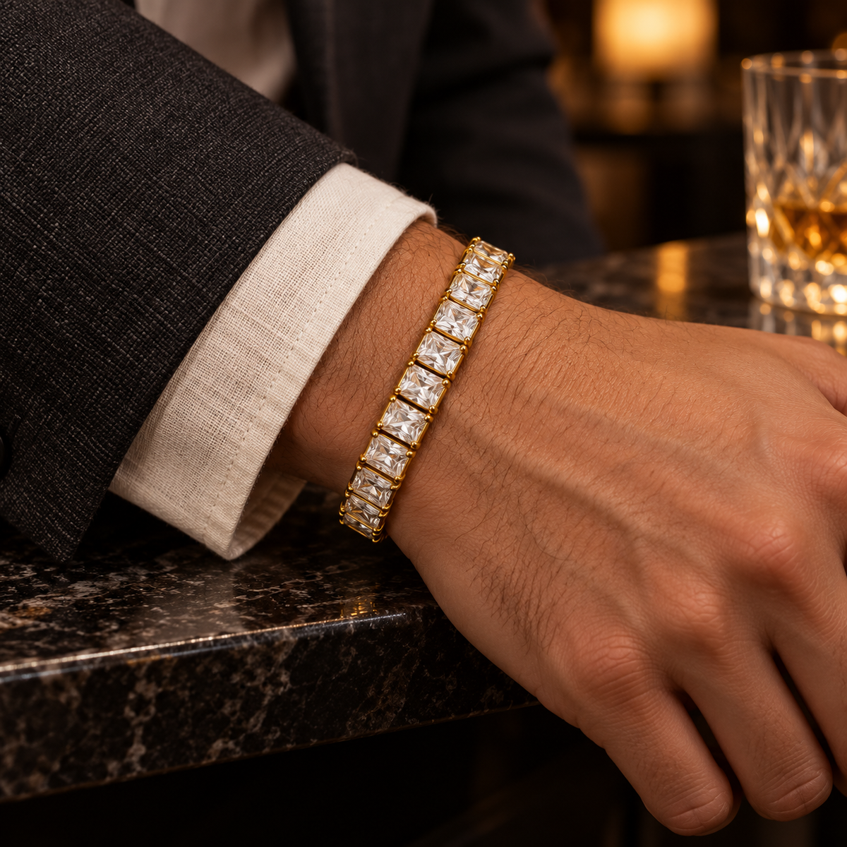 Men's Prism Row Tennis Bracelet in 18K Gold Plated Steel / Cubic Zirconia – contextual scene, on wrist with a cream linen cuff