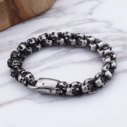 Men's Four Face Skull Bracelet in Silver-Tone Steel – original skull clusters and push clasp detail