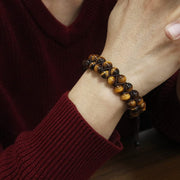 Men's Crossweave Tiger Eye Bracelet in golden-brown natural stone – on wrist with burgundy knitwear
