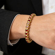 Men's Round Bezel Red Tennis Bracelet in Steel; Gold-Tone Finish; Red Cubic Zirconia – contextual scene, on wrist